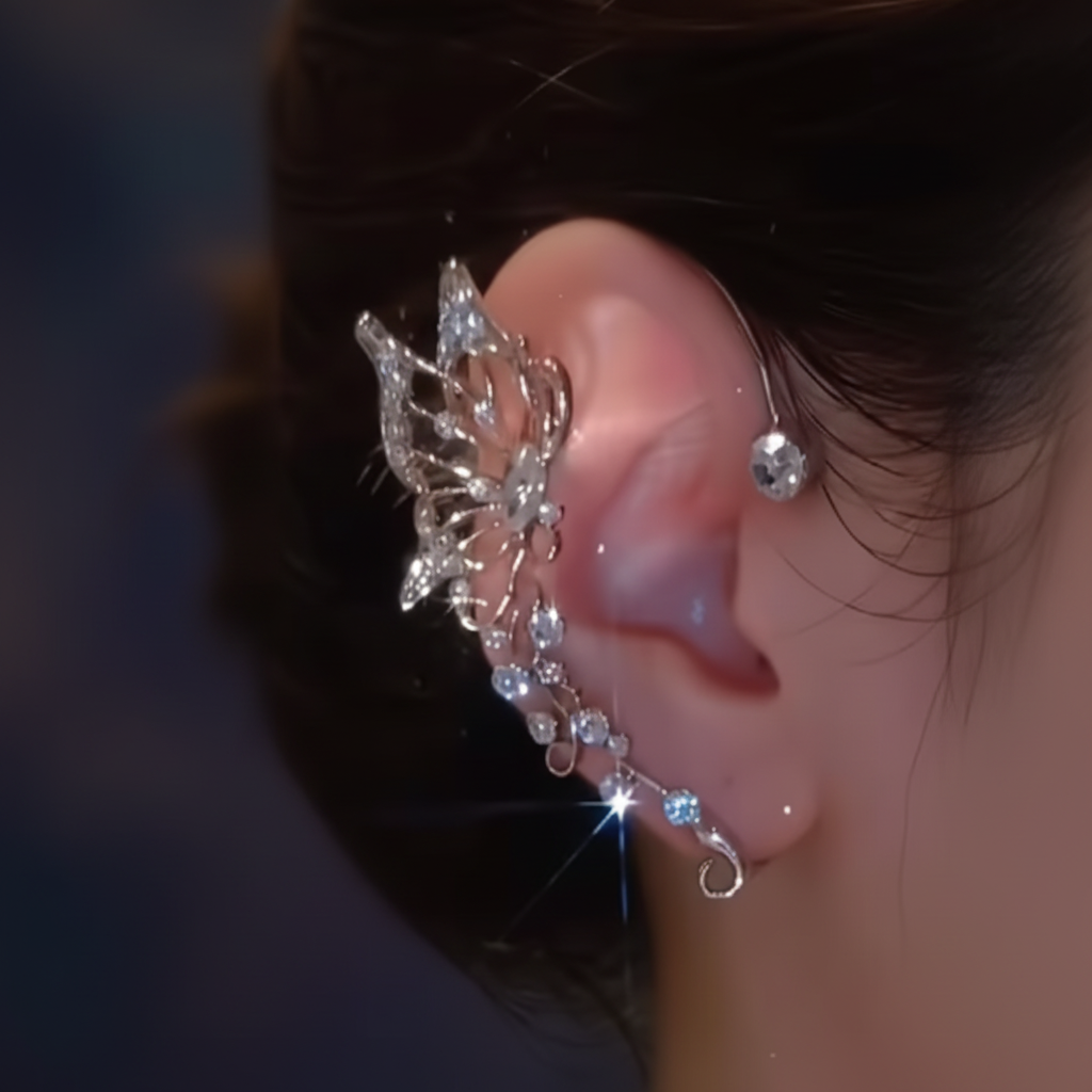 Crystal butterfly ear cuff worn on ear, dark moody background